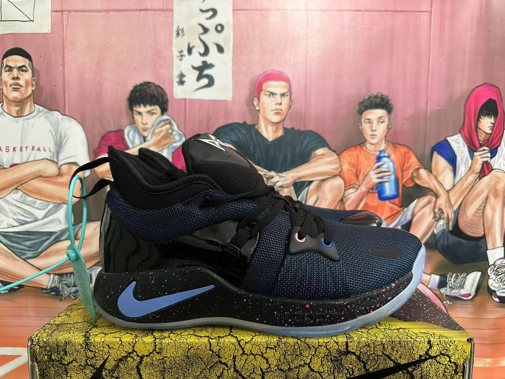 Side view of a black Nike basketball sneaker with a blue Swoosh, speckled midsole and mesh-textured upper.
