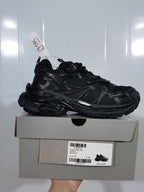 Black Puma 1090 Runner 2 sneaker displayed on its box; the label shows style 779066 W3RP 1090 Runner 2, all black, and size E 40.