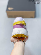 Rear view of the shoe showing the padded collar, purple heel panel, yellow pull tab, and yellow outsole.