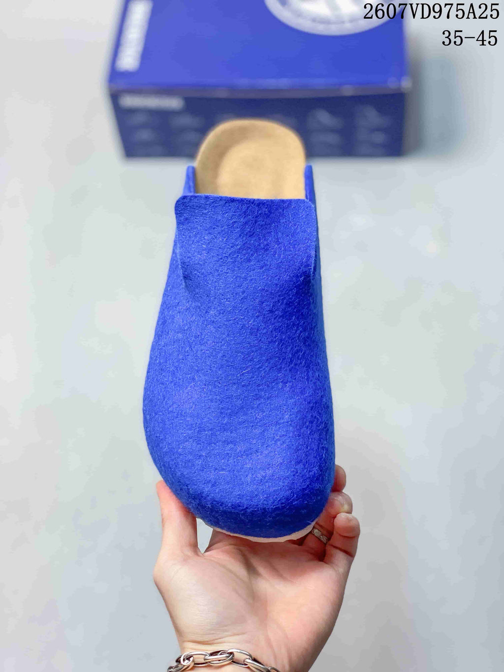 Front view of a blue rounded-toe clog with a wide slip-on opening.