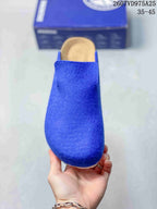Front view of a blue rounded-toe clog with a wide slip-on opening.