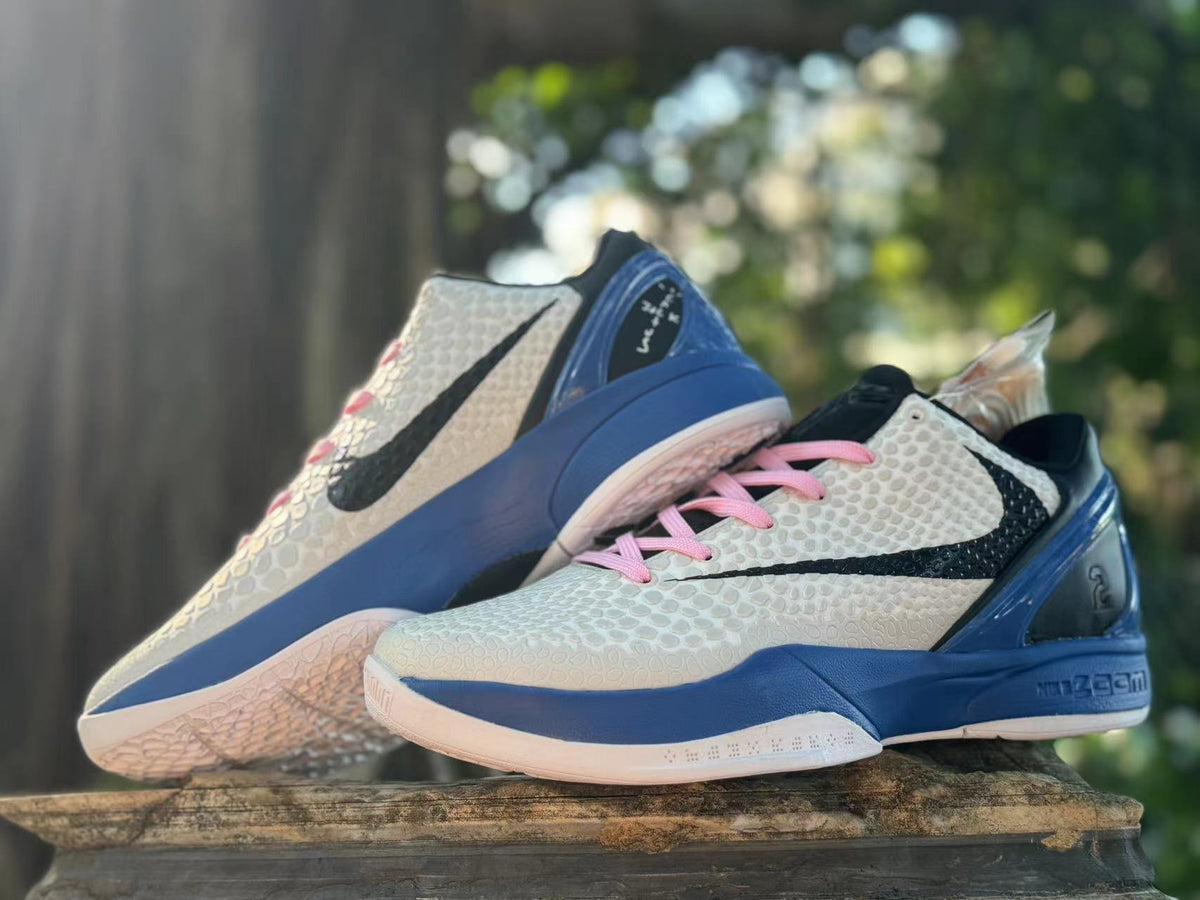 Pair of white, blue, and pink Kobe 6 basketball shoes in an angled view.