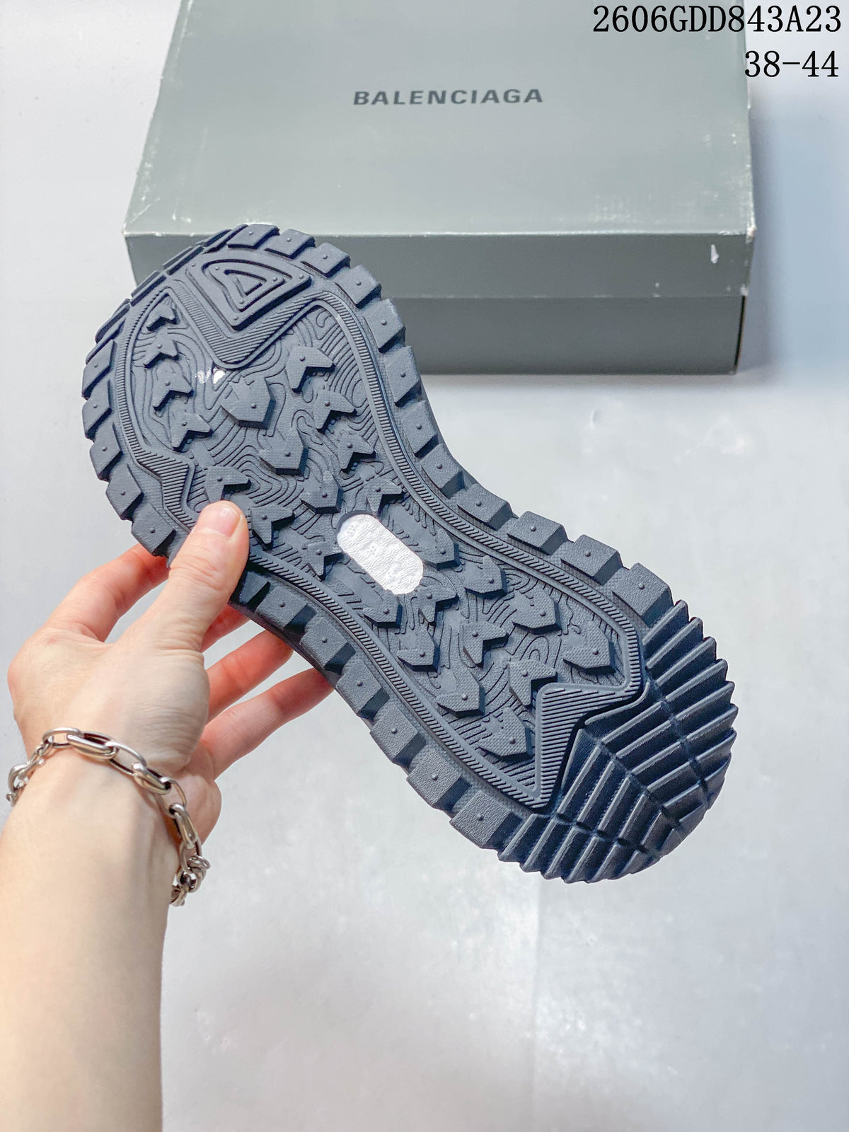 Close-up of the textured tread on the grey sneaker outsole.