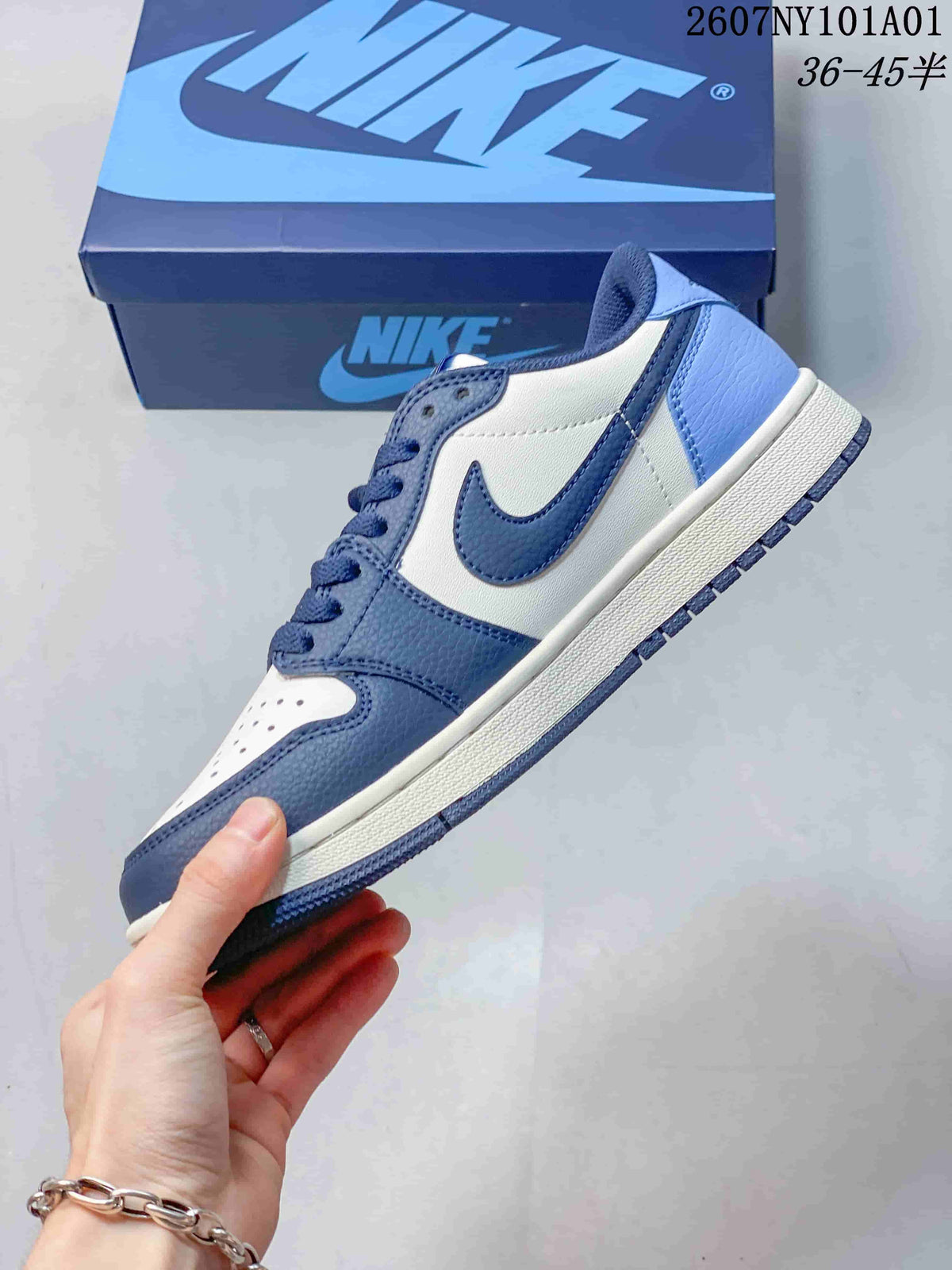 Side view of the low-top sneaker with white panels, blue overlays, and a Swoosh