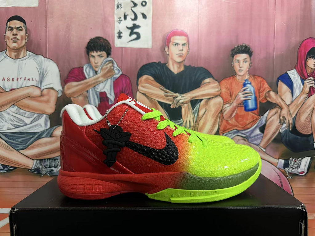 Side view of a red and volt green Nike Kobe basketball shoe with a black Swoosh and charm.