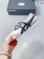 Side view showing the rounded toe, stitched panels, double buckle straps, and textured outsole.