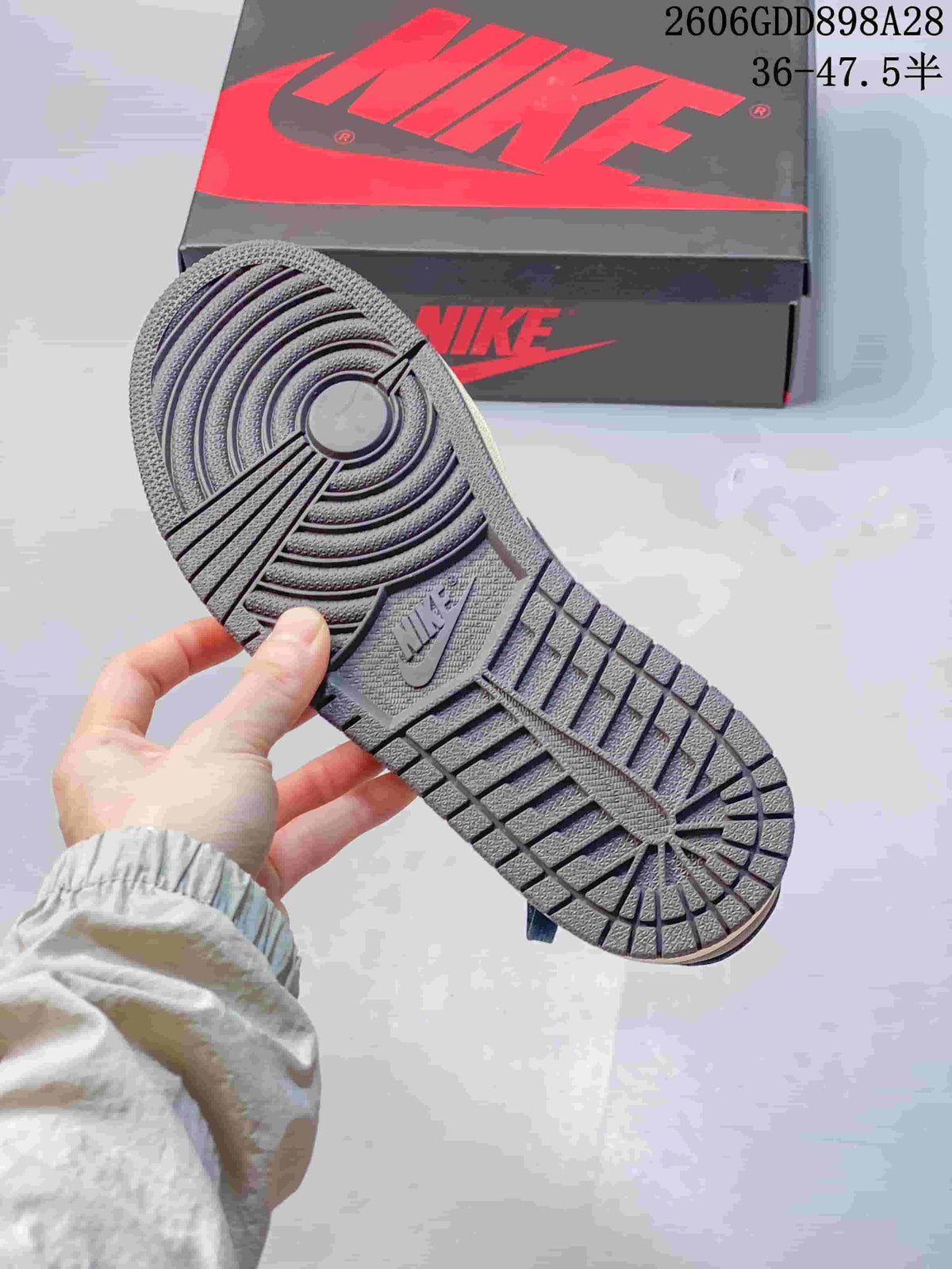 Close-up of the sneaker outsole with circular tread and a visible Nike mark