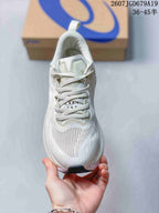 Top view of a white lace-up ASICS running sneaker showing the tongue, laces, ventilation area, and dark toe outsole section.