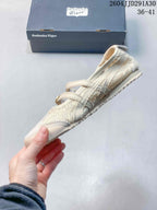 Side view showing the perforated upper, buckle straps, and low-profile sole.