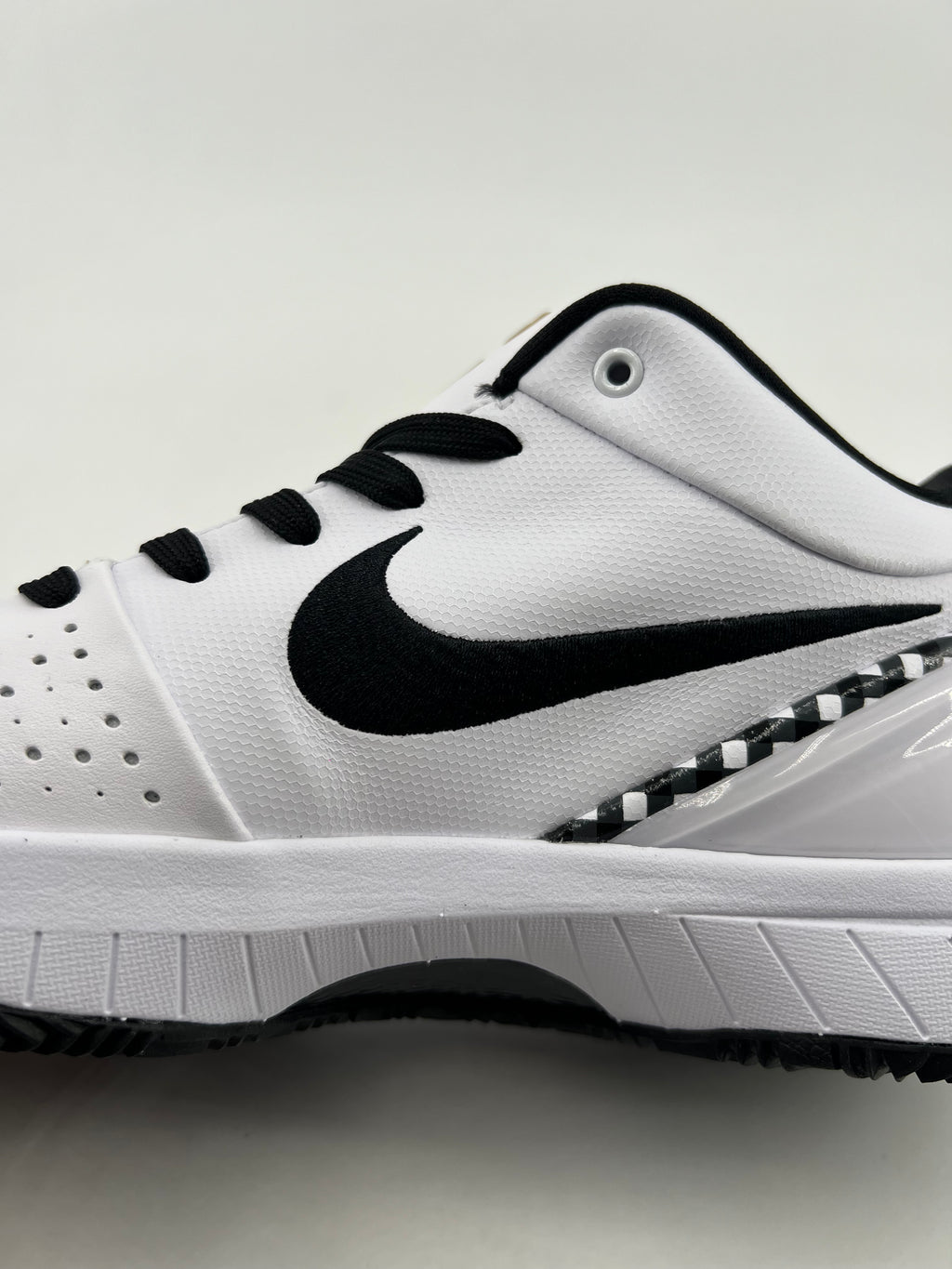 Side view of the shoe showing the Swoosh and checkerboard heel accent