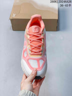 Top view showing the coral laces, padded tongue, and pink-and-white toe design.