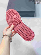 Close view of the red rubber outsole with circular traction and molded branding.