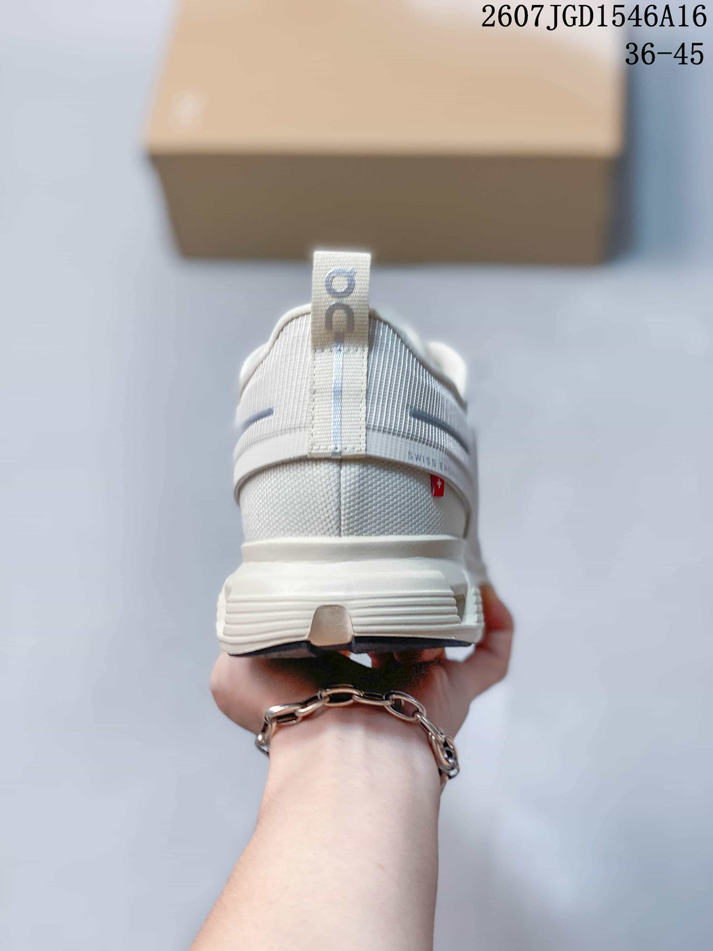 Rear view of the white and grey sneaker showing the heel pull tab, padded collar and layered heel construction.