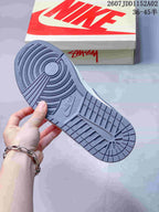 Close-up of the gray patterned outsole of the low-top sneaker.