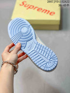 Underside of the sneaker showing the light blue rubber outsole and circular traction pattern.