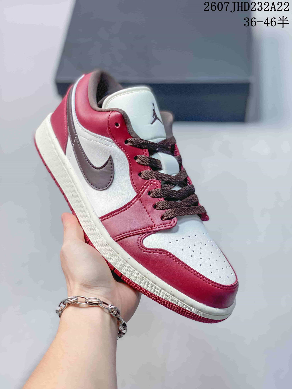Angled side view showing the red and white low-top upper with a dark brown Swoosh.