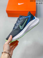 Side view of the low-top sneaker showing the dark upper, green side logo, blue heel panel, white midsole, and green outsole edge; overlay shows style code 2607JXY979A19 and size range 39–45.