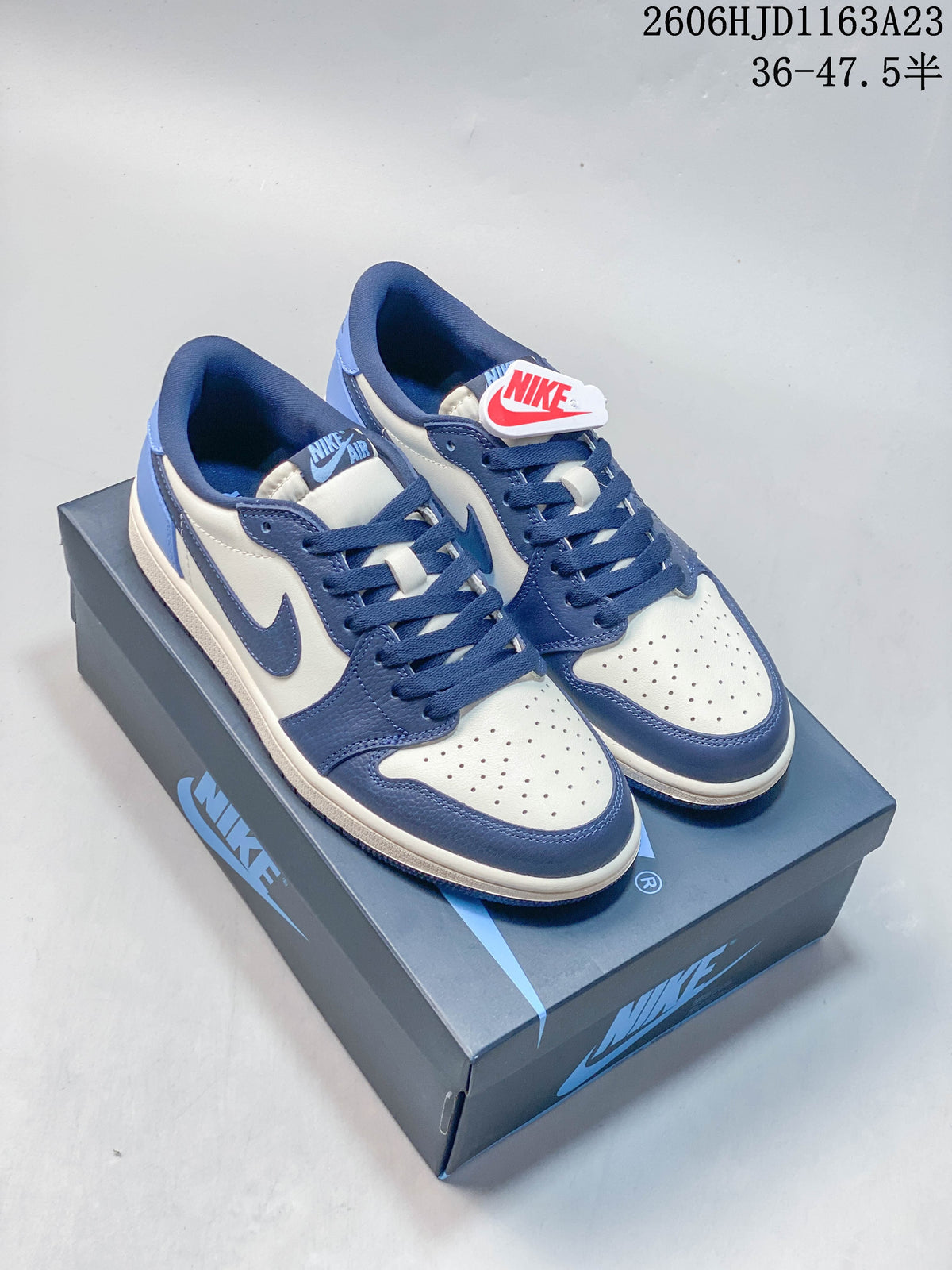 Blue and white Jordan Air Jordan 1 Low sneakers displayed on a shoebox