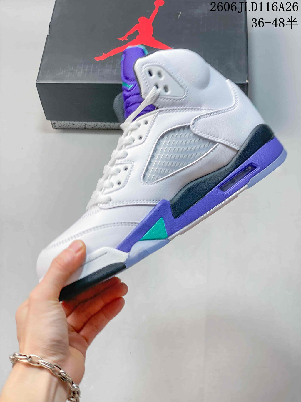 Side profile showing the white upper, perforated panel, purple midsole and teal accents