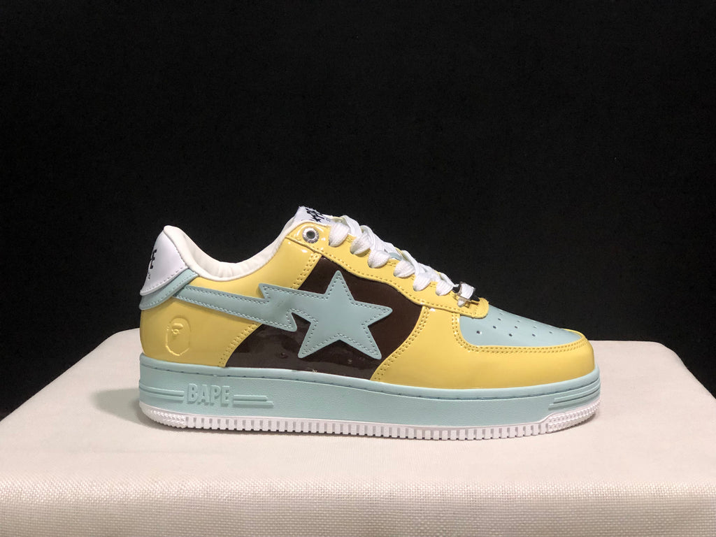 Outer side profile of a BAPE STA sneaker showing the large light blue star detail, yellow panels, and raised sole branding.