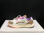Side profile highlighting the beige heel panel, layered white upper, cream sculpted midsole, and dark outsole.
