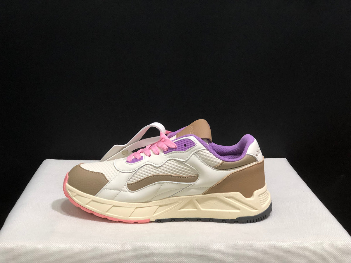 Side profile highlighting the beige heel panel, layered white upper, cream sculpted midsole, and dark outsole.