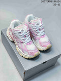 Pair of pink and white Balenciaga Runner sneakers displayed on a shoebox.