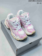 Pair of pink and white Balenciaga Runner sneakers displayed on a shoebox.