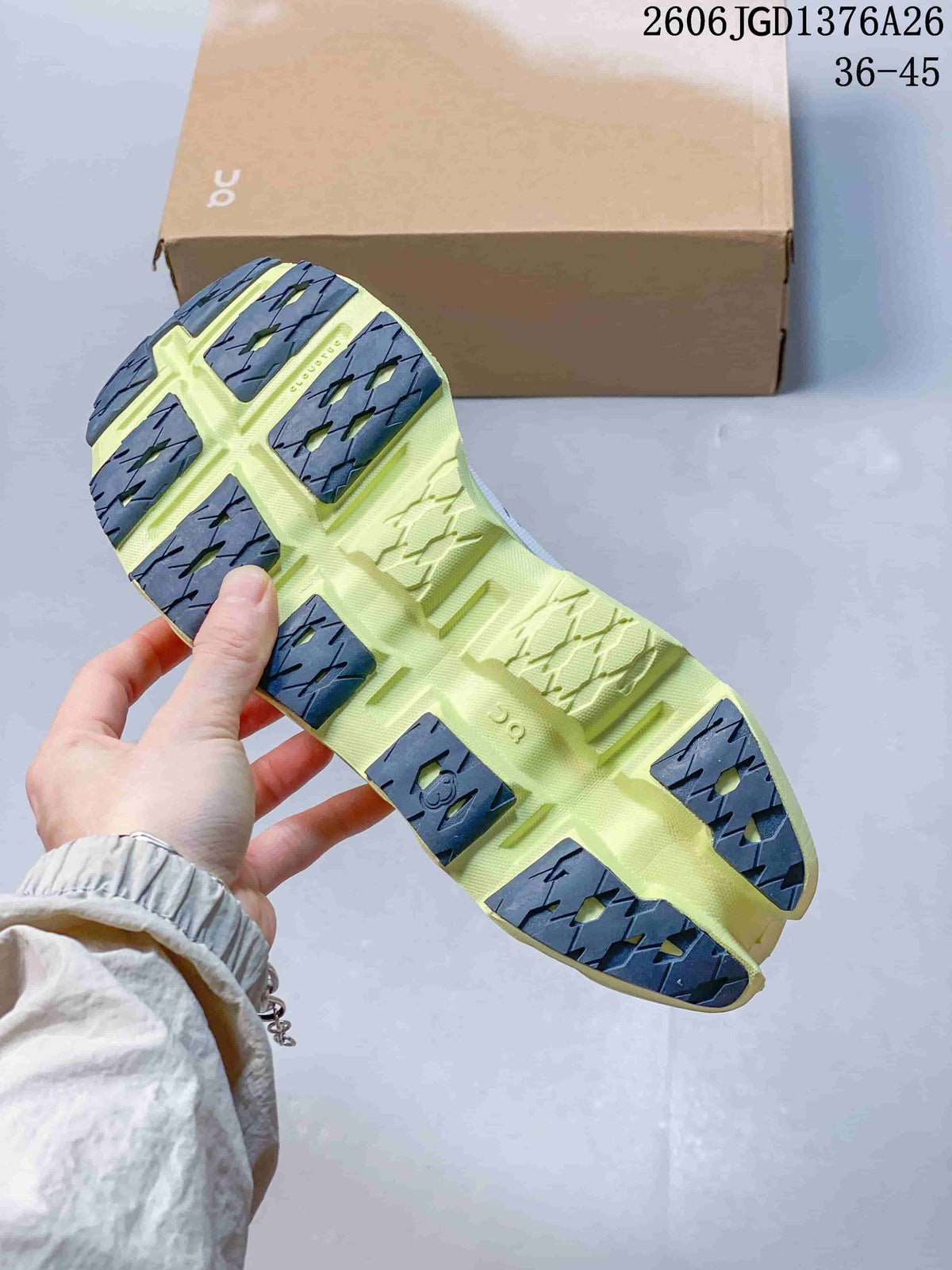 Underside view of the shoe showing a lime outsole with dark segmented traction sections and geometric tread details.
