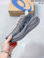 Side profile of the dark gray and navy low-top sneaker with layered sole details.