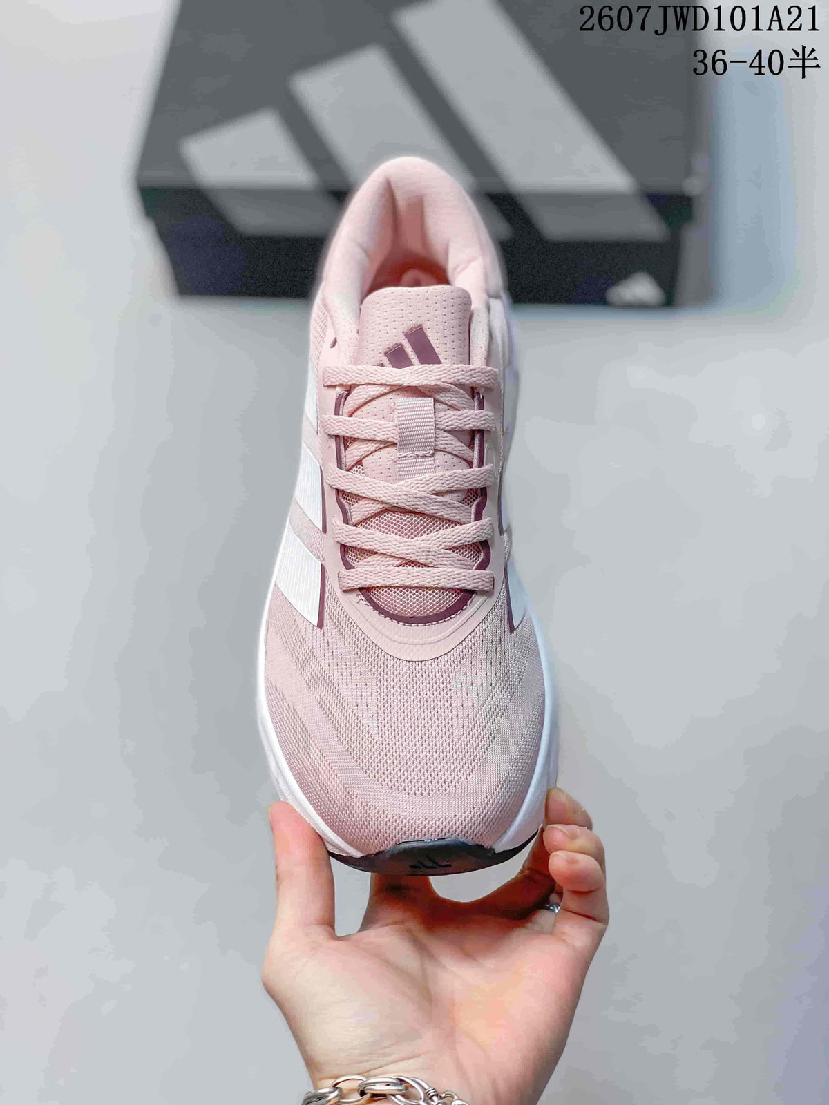 Top view of the pink lace-up sneaker showing the perforated-looking tongue area, laces and Adidas logo.