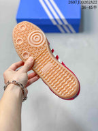 Close view of the gum-colored outsole showing its textured tread pattern and adidas branding.