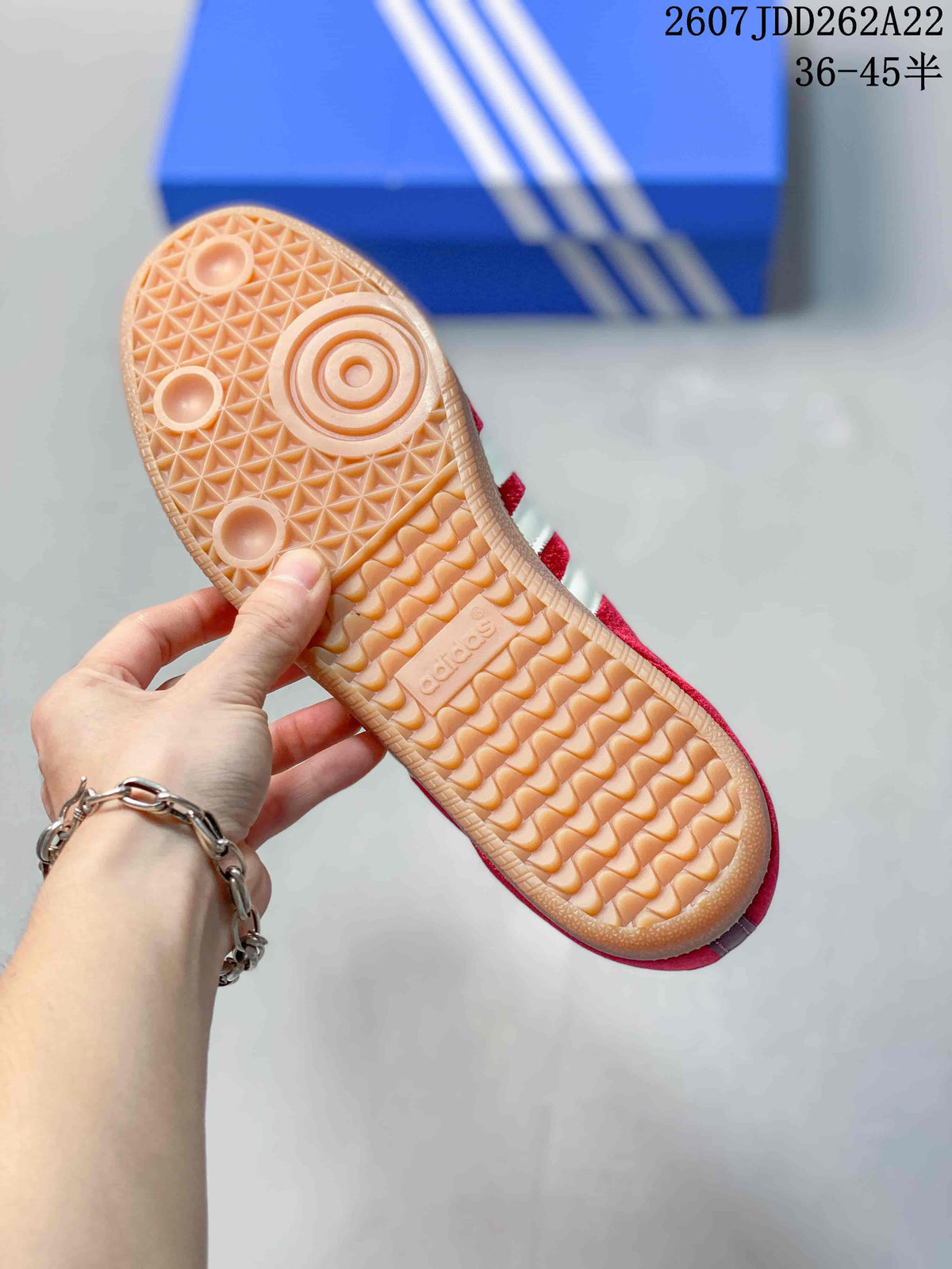 Close view of the gum-colored outsole showing its textured tread pattern and adidas branding.