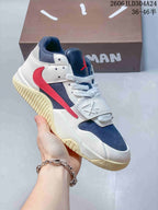 Angled side view of the low-top sneaker with cream, navy, and red details