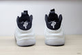 Rear view of white and black Nike Little Posite One GS sneakers