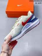 Side profile of the white running sneaker with red Swoosh branding, blue heel accents, and layered midsole.