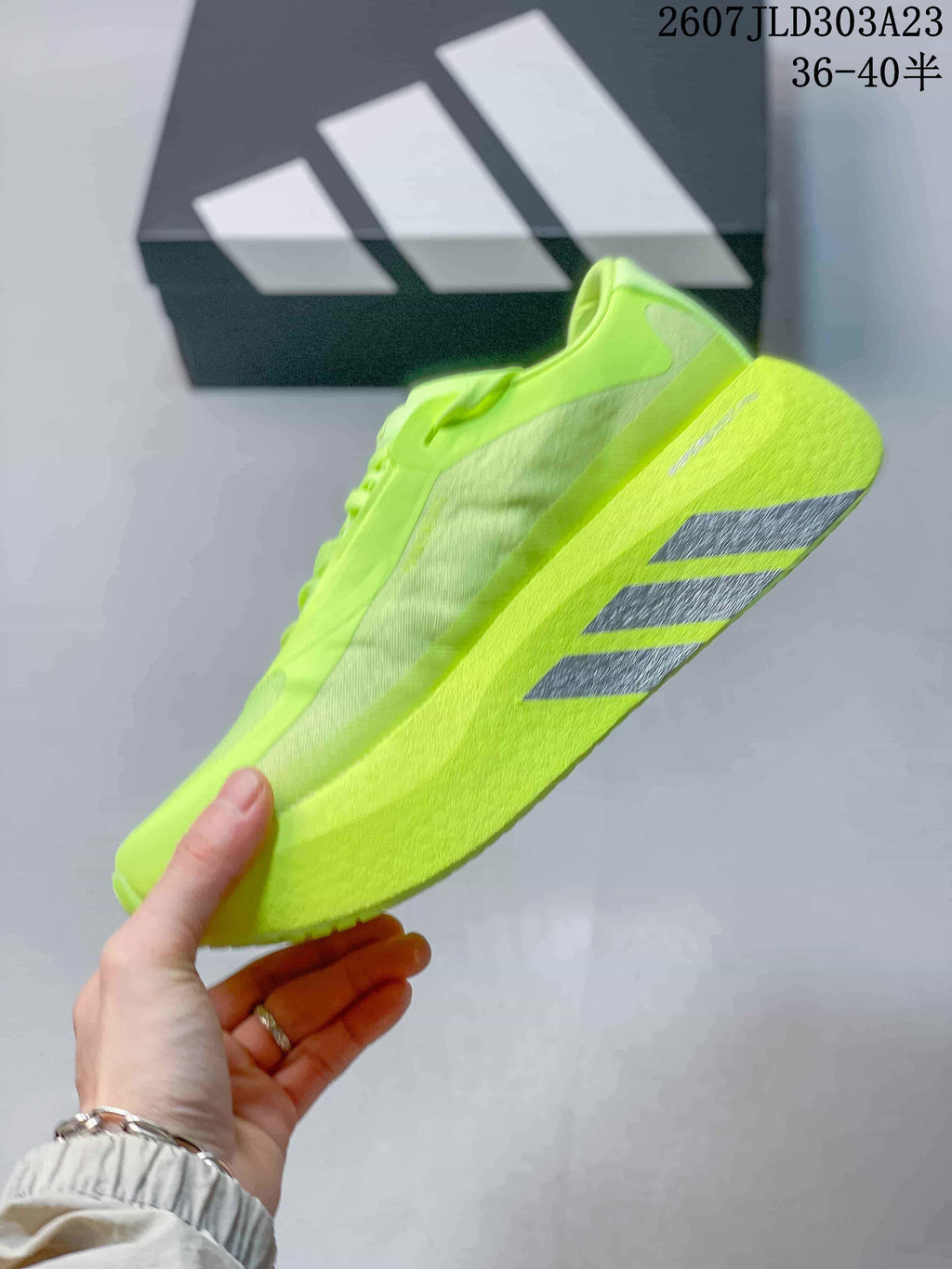 Side view showing the mesh-like upper panels and gray outsole stripe details.