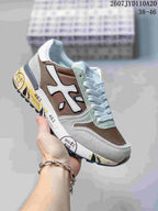 Brown, gray, and white Premiata sneaker with layered panels and a printed midsole.
