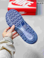 Underside view showing the textured blue outsole and tread pattern of the sneaker