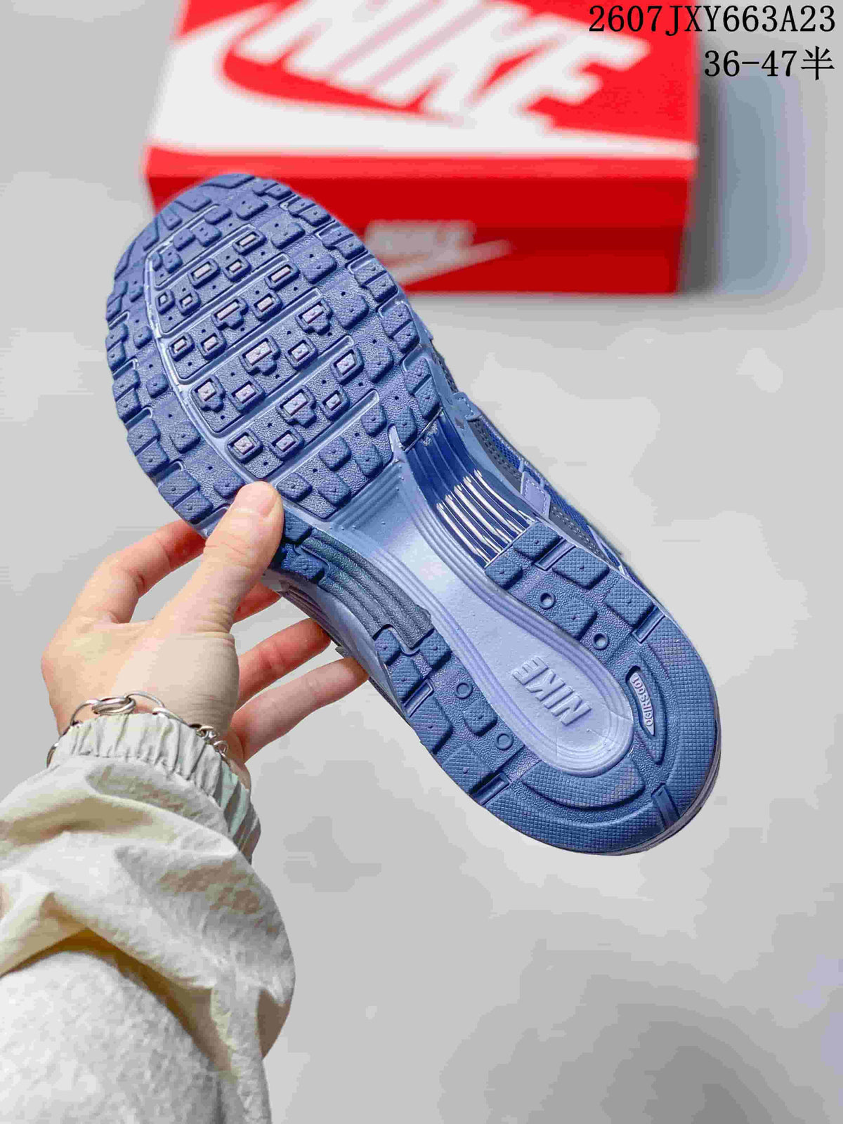 Underside view showing the textured blue outsole and tread pattern of the sneaker
