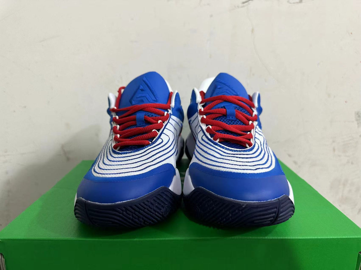 Front view of white and blue Nike basketball shoes with red laces.