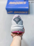 Rear view of a white Brooks sneaker with a dark heel detail and pink outsole accents.