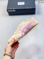 Side profile showing the beige upper, layered pink side stripes, lace-up front, and low sole.