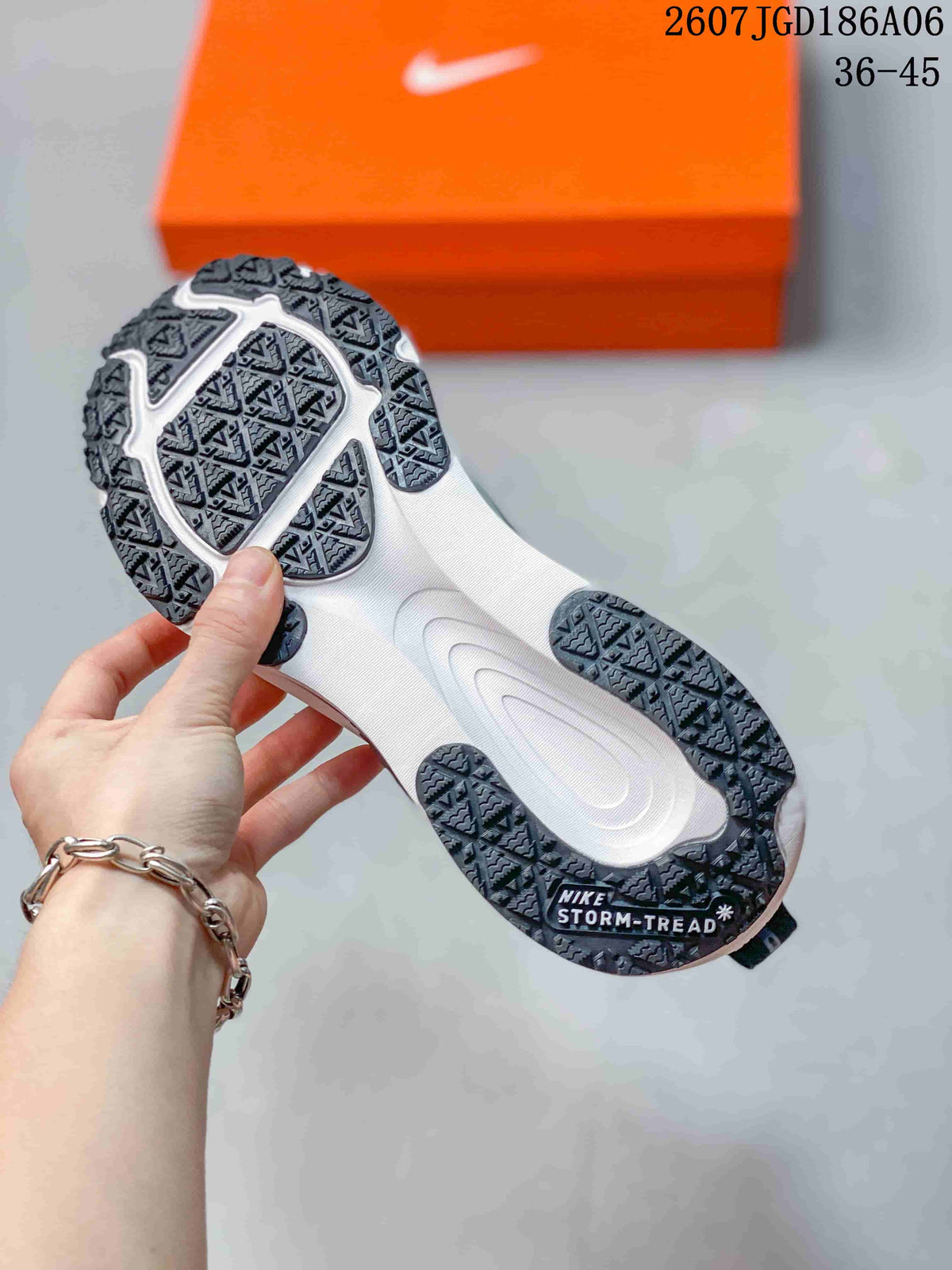 Underside view showing the white midsole and black patterned outsole with visible Storm-Tread marking.