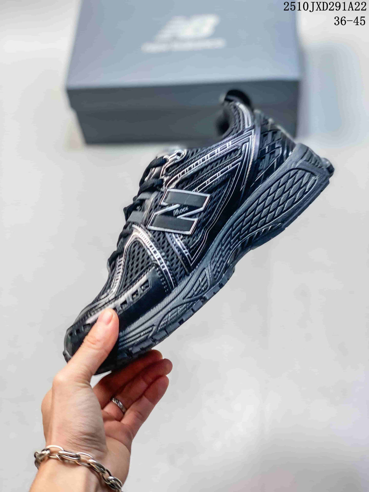 Side profile of a dark gray and silver New Balance M1906AD sneaker