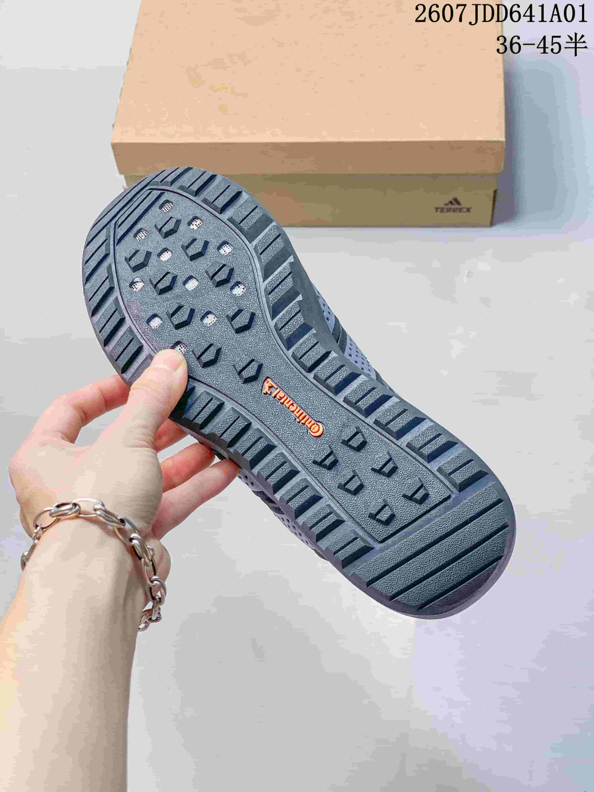 Close-up of the gray sneaker's treaded outsole with raised traction blocks.
