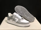Angled view of the sneakers with one shoe lifted to show the patterned grey outsole.