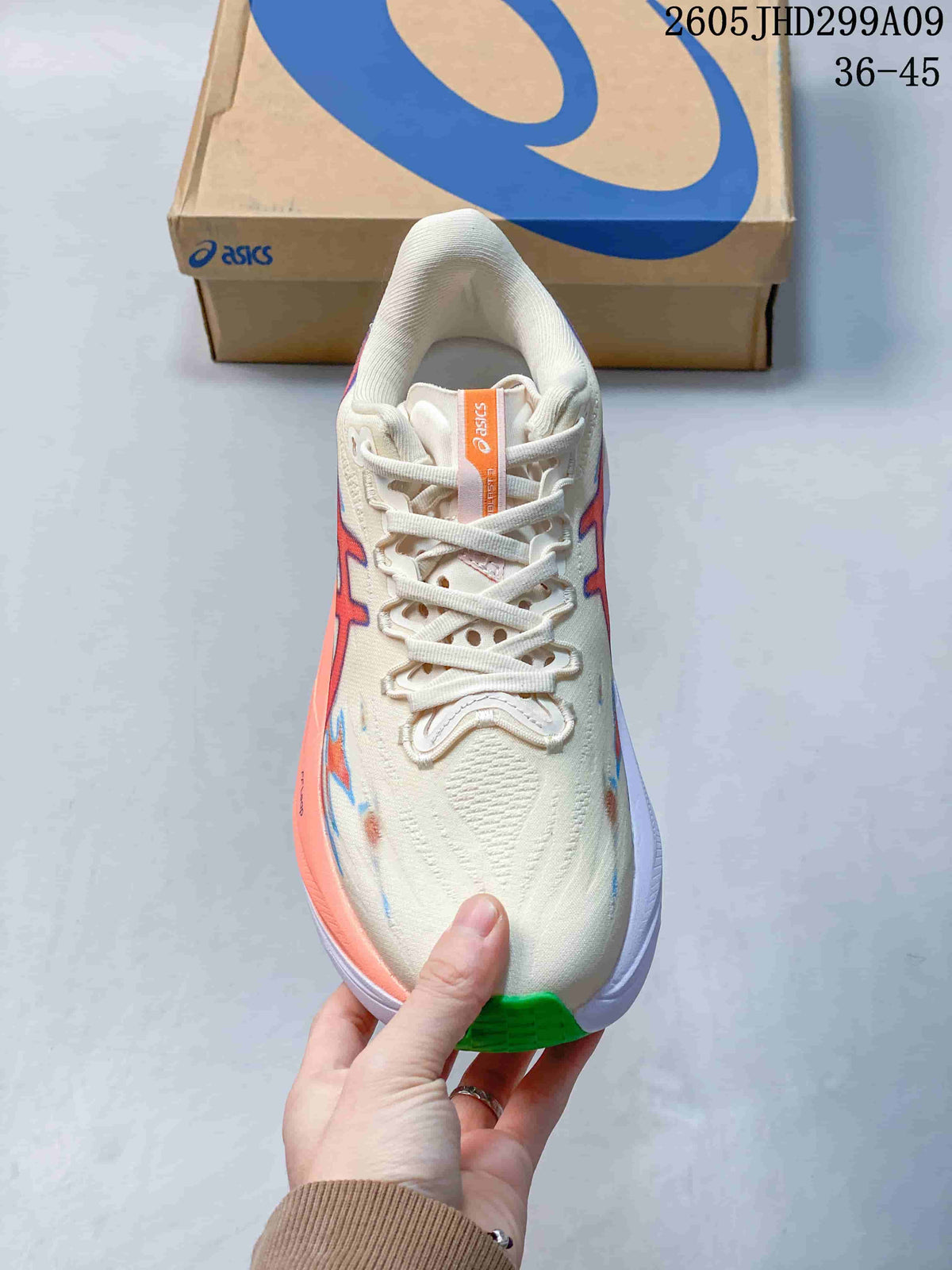 Top view of the cream running shoe with white laces and colorful accents