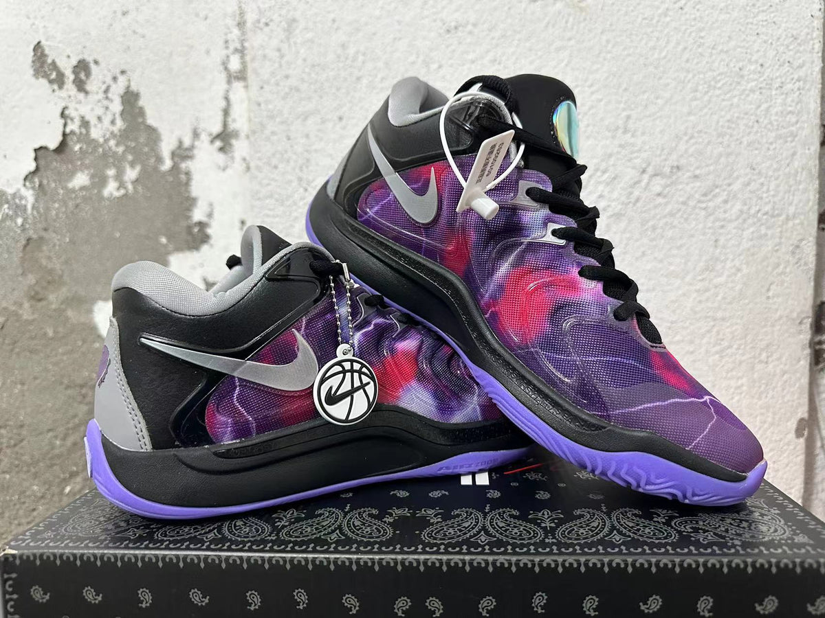 Two black and purple basketball-style sneakers displayed at an angle