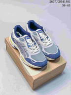 Pair of blue, gray, and white ASICS GEL-NYC 2.0 sneakers on a shoe box